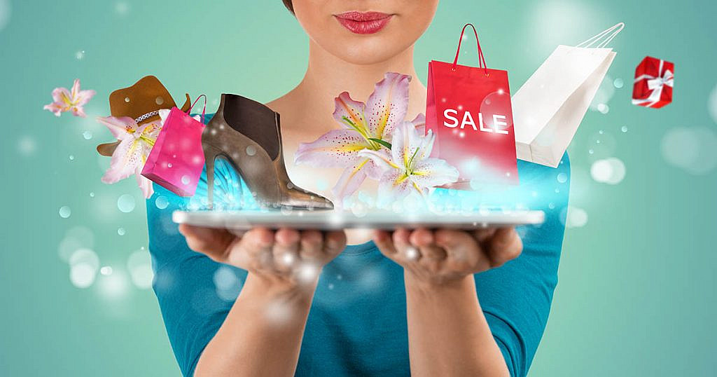 picture of online promotions with woman holding a laptop computer with shopping items popping out of the screen
