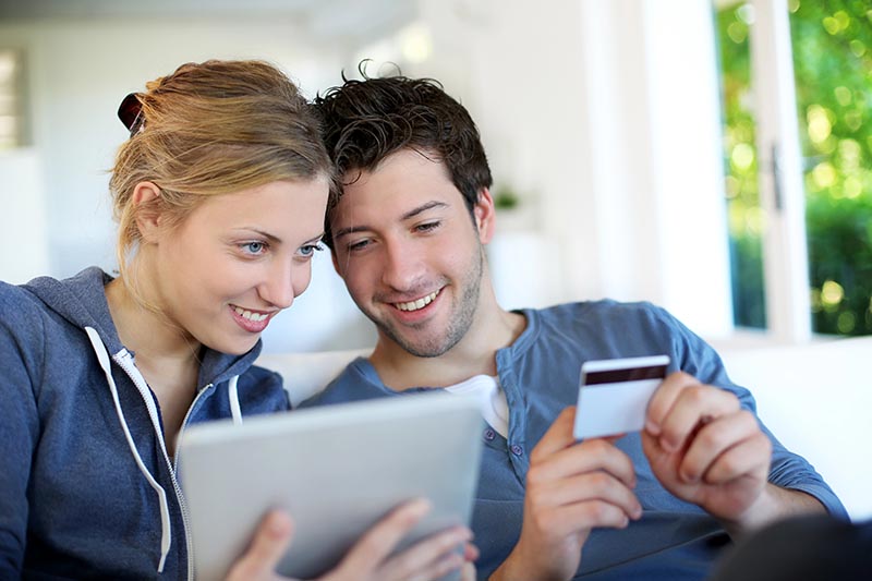 Happy young couple doing shopping on internet - CRO services